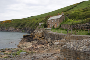 little house pictured in Port Quin, one of the famous filming locations for The Salt Path in Cornwall